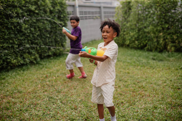 istock Boy is playing with a water gun 2151975862