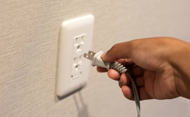 istock Hand insert a plug of the phone charger into socket. 2151976609