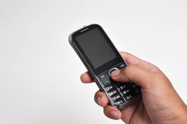 istock Hand holding Old Mobile Phone isolated on white background 2151979659