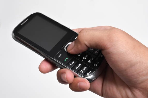istock Hand holding Old Mobile Phone isolated on white background 2151979690