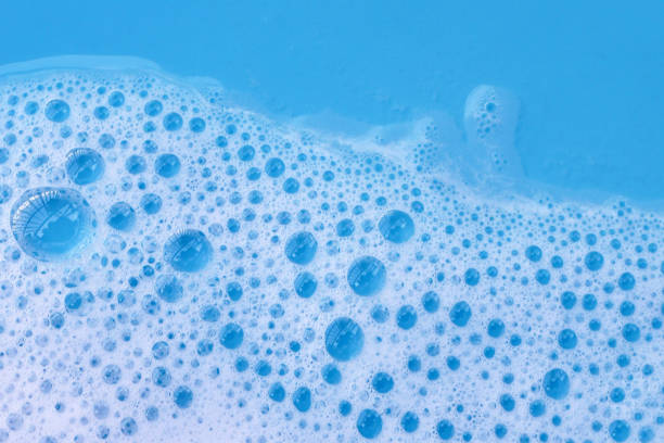 istock Detergent foam bubble on water. Blue background, Soap sud 2151980037
