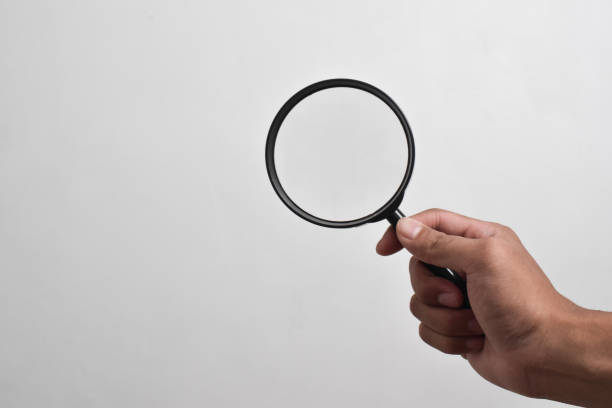 istock Hand holding Magnifying Glass 2151980475