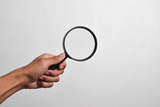 istock Hand holding Magnifying Glass 2151980485