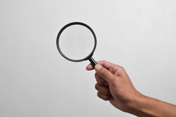 istock Hand holding Magnifying Glass 2151980493
