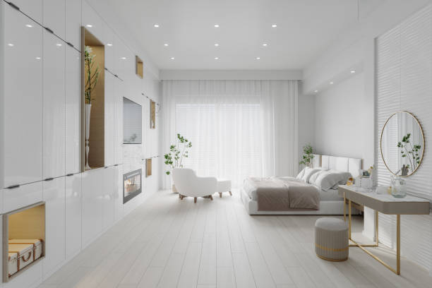 Side View Of Modern Bedroom Interior With Dressing Table, Double Bed, Television Set And Armchair