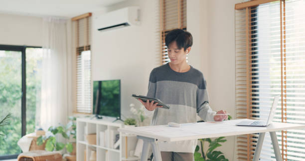 istock Entrepreneur Reviewing Data on Tablet in Modern Home Office. 2151985445