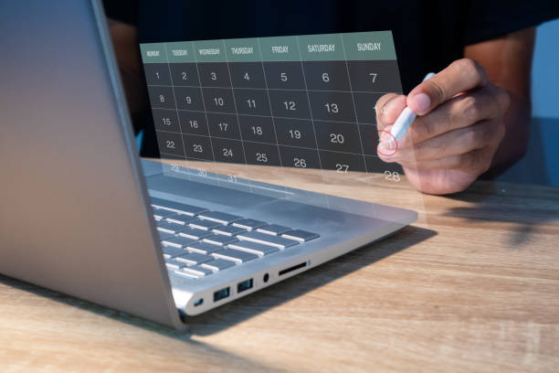 istock A calendar on the virtual screen. A man manages time for an effective schedule. 2151986709