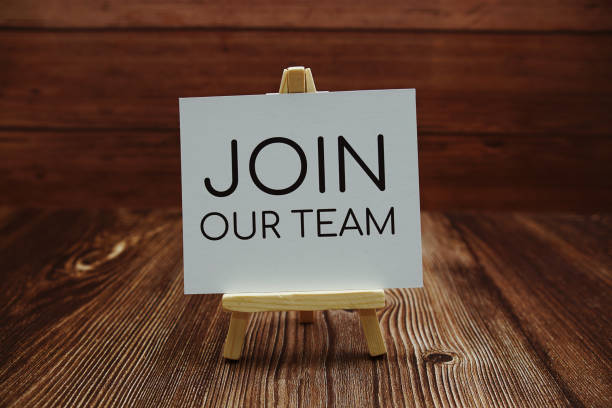 Join Our Team text on paper card on wooden background