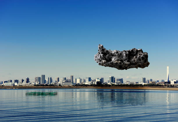 Meteorite floating in mid-air over the sea against urban skyline.