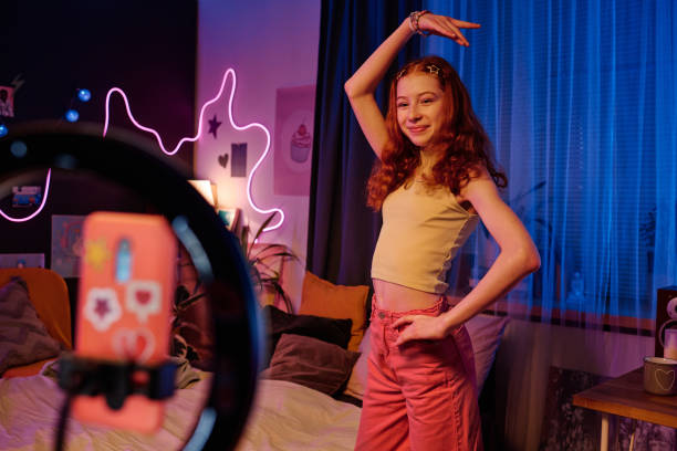 istock Red-haired Girl Dancing In Front Of Smartphone Camera 2151988290