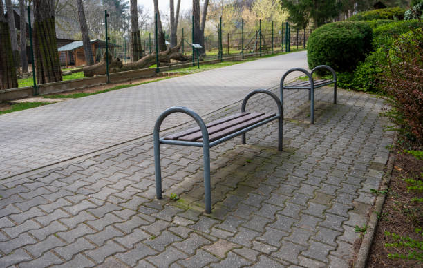 istock Bench for sitting by sidewalk in the park. 2151989173