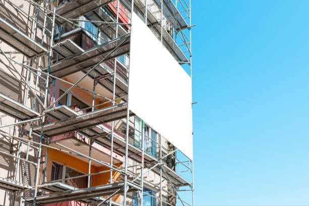 istock Blank white mockup advertisement hanging on the modern building under construction. Reconstruction of a building with white billboard. 2151989434