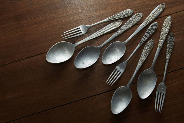 istock Several old spoons and forks made of silver with antique ornaments 2151989595