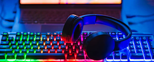 istock Gamer workspace concept.Gaming gear, keyboard, joystick, Headset illuminated background with RGB Color.Dark shot.Banner,advertisement. 2151990055