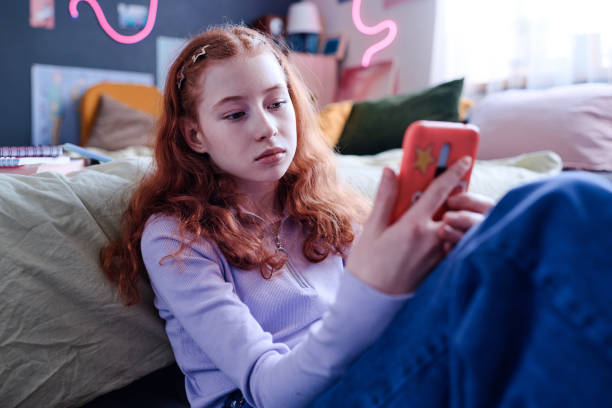istock Bored Girl Looking At Smartphone Screen 2151990306