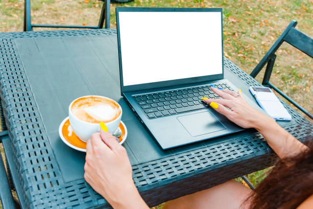 istock Young Business Woman working with empty blank white screen laptop.Business summary charts at concrete table in outdoors cafe.empty white screen mockup.Copy space.Closeup. 2151990783