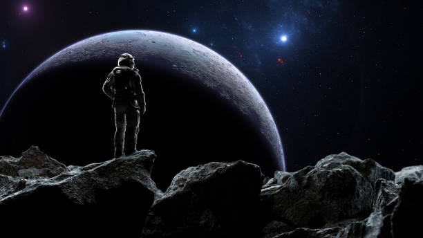 istock Astronaut gazes at a planet from an asteroids surface against a starry backdrop 2151991060