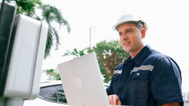 istock Qualified technician working with laptop for home EV station. Synchronos 2151992185