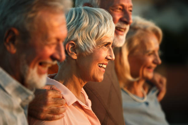 istock Happy senior friends standing embraced in nature. 2151992744