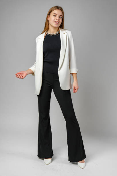 istock Woman in Black Top and White Jacket Posing in Studio 2151993811