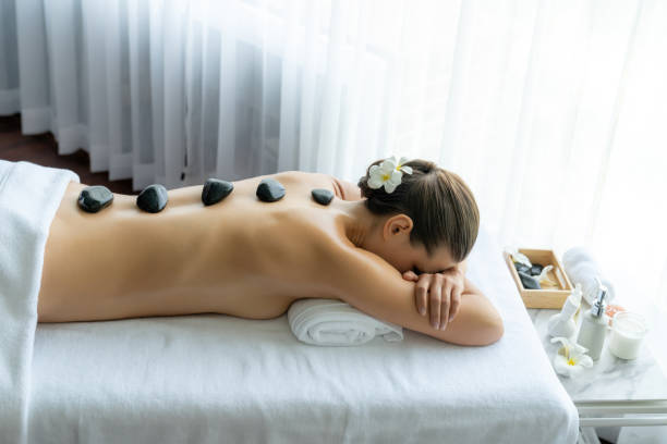 istock Hot stone massage at spa salon in luxury resort. Quiescent 2151994659
