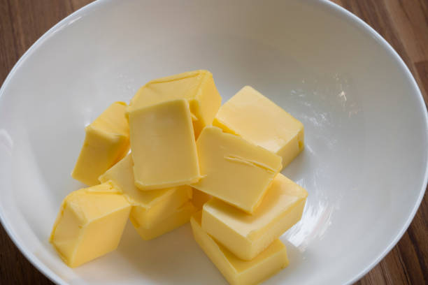 istock Butter slices are placed on a plate, Cut butter into cubes for baking cake 2151995094