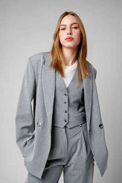 Woman in Gray Suit and White Shirt posing in studio