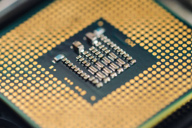 The technician is putting the CPU on the socket of the computer motherboard.