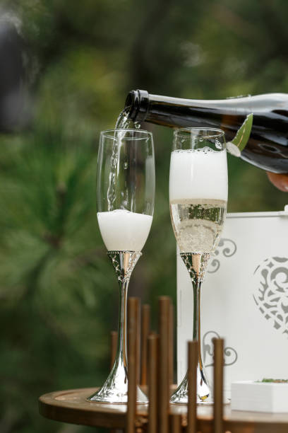 istock Glasses with golden stems are filled with champagne 2151995813