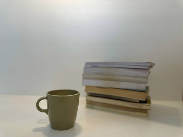 istock Coffee cup next pile of books. 2151996041