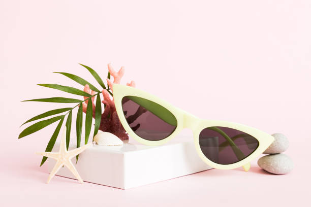 istock sunglasses with seashell lying on table background. Sunglasses on summer background. Top view flat lay with copy space for text 2151998810
