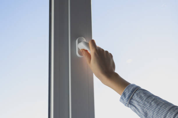 istock Woman is opening plastic window at home for airing. Close up. 2151999706