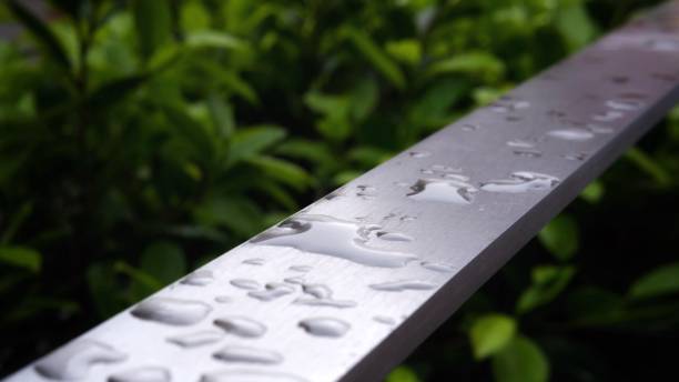 istock Raindrops on a metal surface. Dew drops on a steel railing close-up. 2152000836