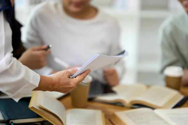 istock Cropped shot of professor assisting her students working on group project in the classroom 2152001829