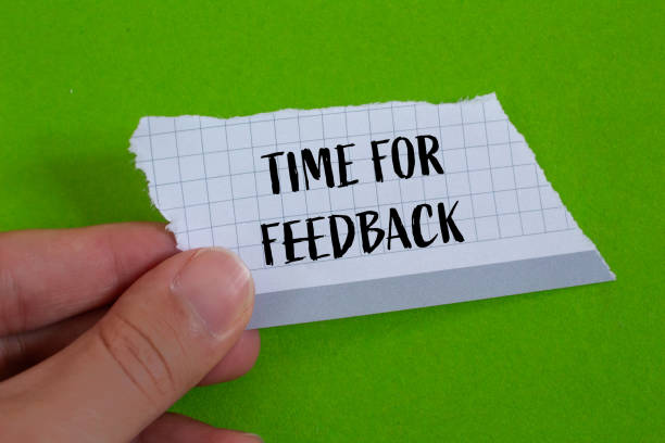 istock Time for feedback words written on ripped paper with green background 2152002866