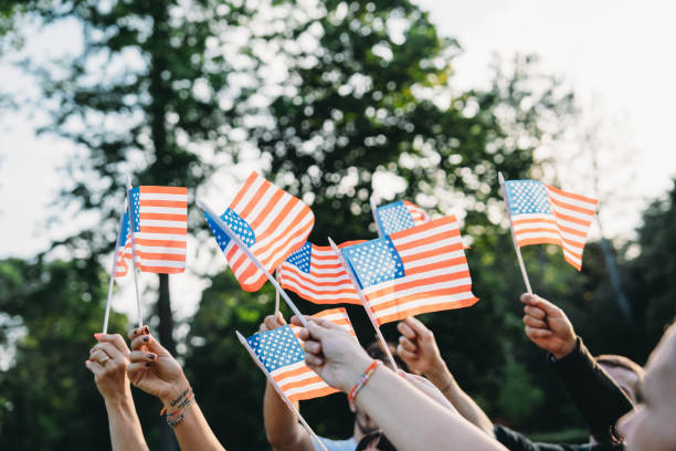 istock A group of people is waving small American flags at sunset 2152004112