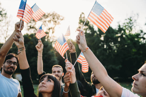 istock A group of people is waving small American flags at sunset 2152004113