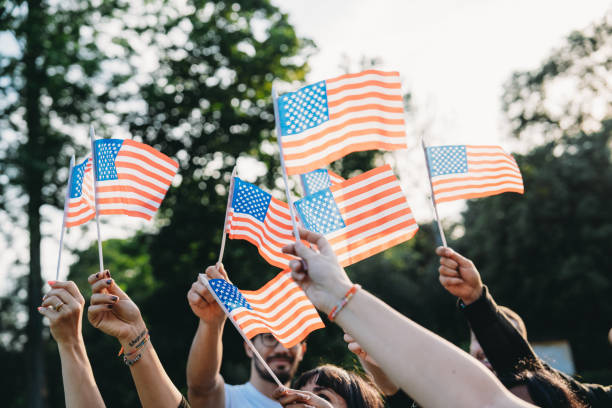 istock A group of people is waving small American flags at sunset 2152004117