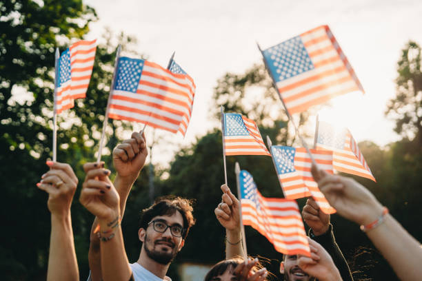 istock A group of people is waving small American flags at sunset 2152004122