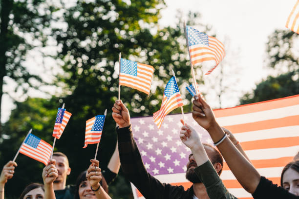 istock A group of people is waving small American flags at sunset 2152004123