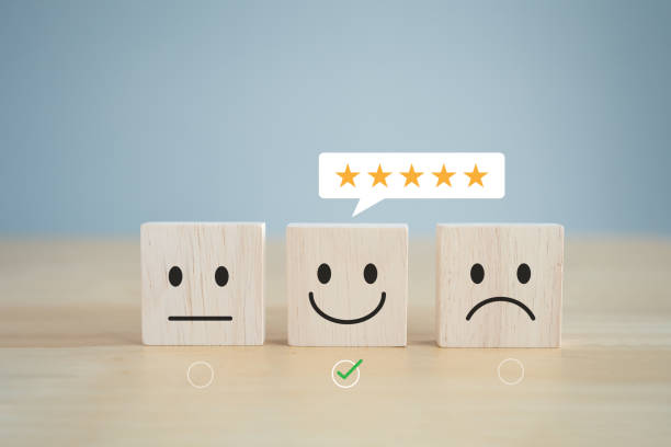 istock Customer satisfaction survey, service experience review and feedback rating concept. Mental health assessment, Emotion. Check mark for choose happy smile face and 5 star on wooden block. 2152004677