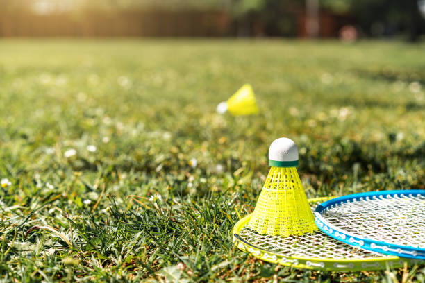 istock Two badminton rackets and shuttlecock on the green grass. Summer sports activity. 2152006366