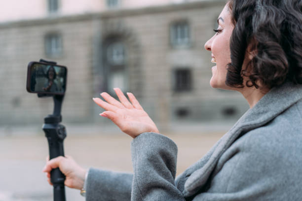 istock Young female content creator using smartphone to record outdoors. 2152006426