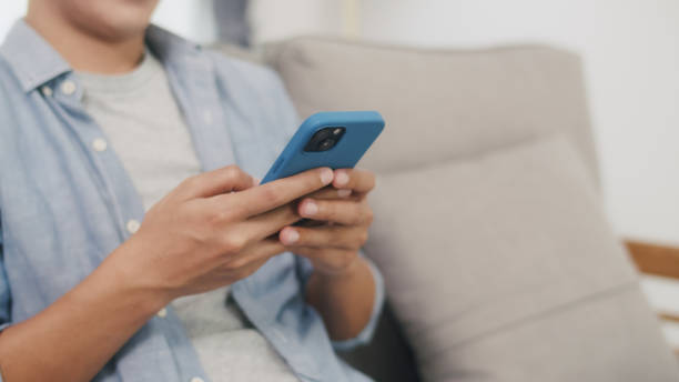 istock Close-Up of Hands Typing on Smartphone. 2152007067