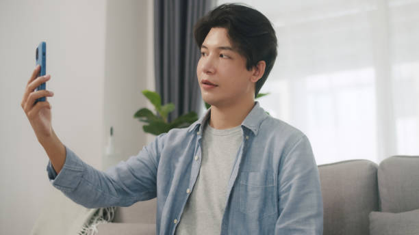 istock Young Asian Man Using Facial Recognition on Smartphone. 2152007085