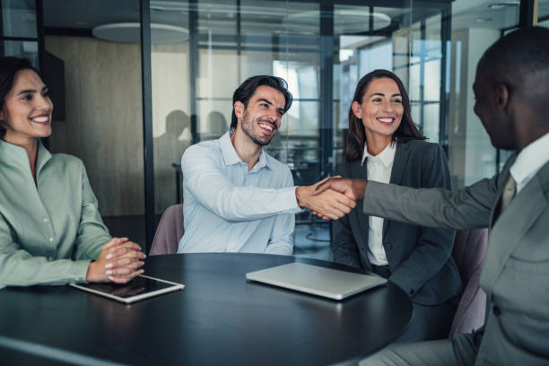istock Businessmen shaking hands across the table. 2152007206