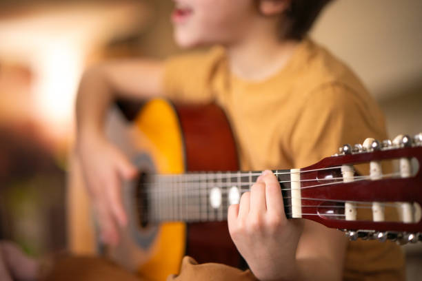 istock Close-up of boy playing guitar 2152012336