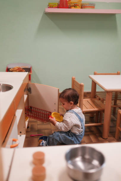 istock A baby boy is playing with a toy kitchen at the playroom 2152014302