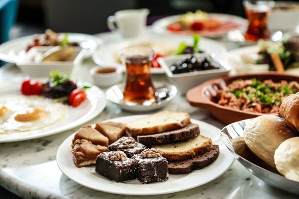 A table covered with numerous plates filled with a variety of delicious food.