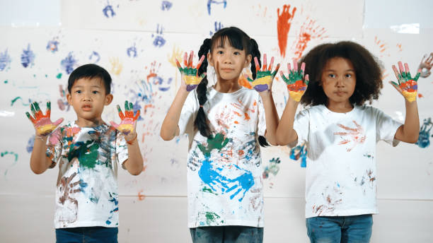 istock Diverse students put hands up together show colorful stained hands. Erudition. 2152015356